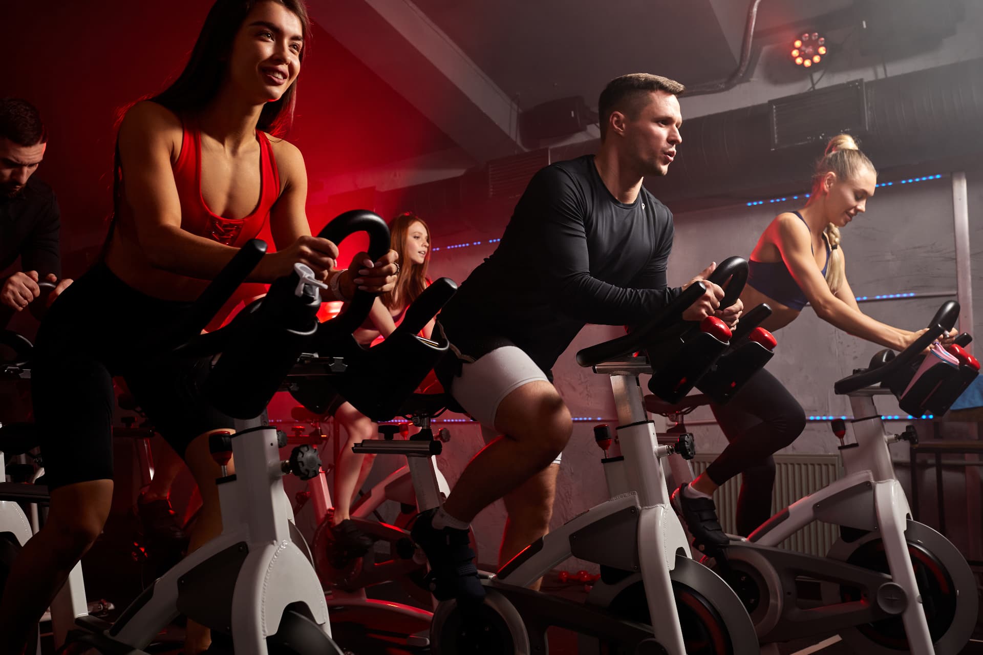 Group exercise class on stationary bikes for cardiovascular fitness and weight management